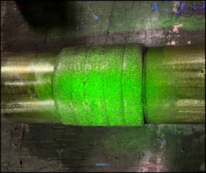 Glowing green magnetism from Magnetic Particle Test (MPI) to show impurities, one of LOGIC's many inspection services.